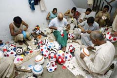 Workers are seen stitching soccer balls at a factory in Sialkot, 120 km from Lahore