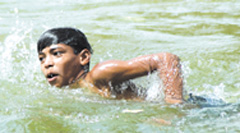 A boy enjoys a swim in the water at Boat Club to beat the heat in the Capital
