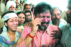 Parents of Sakshi, who passed away on Wednesday at PGI Chandigarh, break down outside a private hospital in Jalandhar on Thursday. 