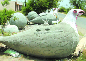 Under-construction water tanks in shapes of eagles and footballs line the road at Lambaran village, near Jalandhar.