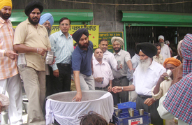Officials of Punjab and Sind Bank serve sweetened water to passersby at a chabeel in Jagraon on Wednesday