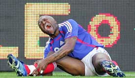 Djibril Cisse of France cries out in pain after being tackled by Chinas Zheng Zhi during a friendly match in St Etienne, France, on Wednesday
