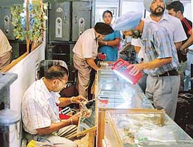 Fingerprint experts look for clues at a jewellery shop in Ludhiana where armed robbers struck
