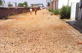 The road leading to Aman Nagar and Akash Nagar on which work has been suspended for the past five months