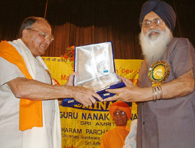 SAD chief Parkash Singh Badal presents a memento to Punjab Governor S.F. Rodrigues in Amritsar on Saturday.