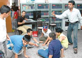Chandrashekhar (right) and Vijay (sitting) with their brood at a theatre workshop. 