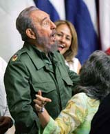 Cubas President Fidel Castro speaks to two unidentified women after the closing ceremony of a seminar on literacy in Havana 