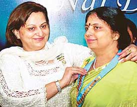 Ms Neeru Khattar (left), the outgoing Chairperson of the Inner Wheel District 308, with the new Chairperson Ms Neeru Guglani at the installation ceremony held at Panchkula on Sunday.