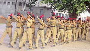 Girl cadets perform a drill on the opening day of the combined annual NCC training camp at Mandi Ahmedgarh on Saturday.