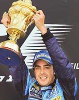 Spanish Renault driver Fernando Alonso holds his trophy after winning the British Grand Prix at Silverstone on Sunday.