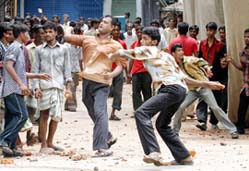 Opposition activists throw stones at the police during a protest