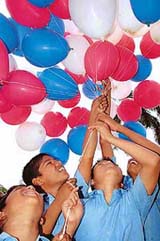 Child labourers release balloons on the occasion of World Day Against Child Labour in Hyderabad