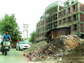 Concrete waste piles up outside an under-construction building of the Municipal Corporation in Jalandhar