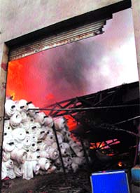 Bales of fibre lie damaged amid flames inside the factory of Shital Fibres Limited in Jalandhar