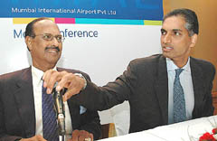 GVK Industries Vice-President Sanjay Reddy  gestures as Chairman Mumbai International Airport Ltd G. V. Reddy  looks on at a press conference in Mumbai