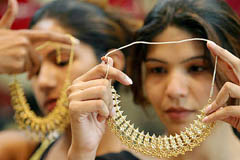 Women admire gold necklaces at a jewellery store in Chandigarh