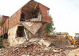 JCBs of HUDA raze illegal structures in Sector 12, Panchkula, on Wednesday.