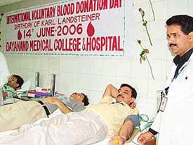 Senior faculty members of the Dayanand Medical College and Hospital donate blood at a camp at the hospital in Ludhiana on Wednesday. 