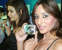 Models pose with a new range of Panasonic digital still and movie cameras in New Delhi