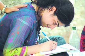 A student fills up an admission form at Delhi University in the Capital