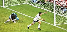 Germanys Oliver Neuville celebrates after geting past Poland goalkeeper Artur Boruc to score a goal during their Group A match in Dortmund on Wednesday