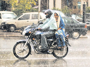 A couple caught in the rain in the Capital on Friday.