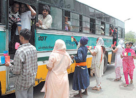 Sikh devotees offering sharbat to people on the occasion of the 400th martyrdom anniversary of Guru Arjan Dev in the Capital on Friday.
