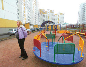 Irina Tarasenko stands in the playground in the compound of a newly built block of flats in Moscow. Tarasenko paid $50,000 for her one-room property when the building was still on the drawing board. It was finished last year but no one could move in because it turned out the developer had sold the same apartments to two or more different buyers.