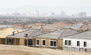 Hotel-casinos on the Las Vegas Strip are seen behind an area of new home construction in Las Vegas. After years of skyrocketing real estate prices, Las Vegas housing market hit a new record for unsold homes and condominiums in May 2006, and developers are beginning to drop prices as the supply of new houses exceeds the demand. Despite the glut of housing, construction in Las Vegas continues unabated as thousands of new residents continue to flock to the city for work.