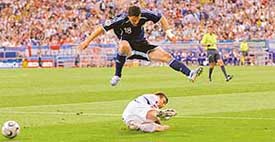 Argentinas Maximiliano Rodriguez jumps over a Serbia and Montenegro player during their Group C match in Gelsenkirchen on Friday