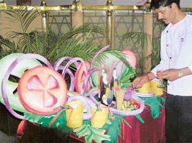 A waiter touches up the spread at Hotel Maya Palace. 