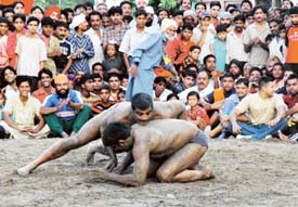 A bout in progress during the 14th annual wrestling competition held at the Field Ganj ground. Ludhiana on Friday.