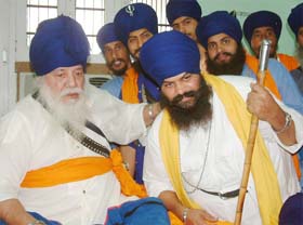Baba Budha Dal chief Baba Santa Singh blesses Baba Balbir Singh after the merger of two factions in Amritsar
