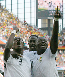 Ghanas Asamoah Gyan (left) celebrates with team-mates Otto Addo and Sulley Ali Muntari (right) after scoring a goal against the Czech Republic during their Group E match in Cologne on Saturday. 