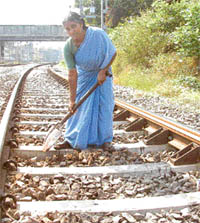 A gangwoman maintaining rail track
