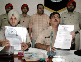 SP Harish Kumar shows documents used in the scam
