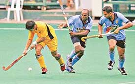 Malaysias Ismail Abu tries to break away from Indias Vikram Pillay and Kanwalpreet Singh during a Pool A match of the Sultan Azlan Shah hockey tournament in Kuala Lumpur on Monday