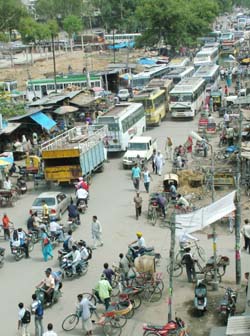 Chaos prevails on the road outside the bus terminus with haphazard parking and encroachments on both the sides