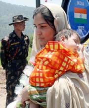 A Pakistani woman enters India after boarding a new bus service between the two countries at Chakka-da-Bagh in Poonch on Tuesday.