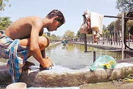 A man washes linen in the fountain water, flouting the prohibitory order in Ludhiana on Tuesday.