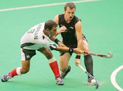 New Zealands Blair Hopping (right) tackles Pakistans Adnan Maqsood during the 15th Sultan Azlan Shah hockey tournament in Kuala Lumpur on Tuesday.