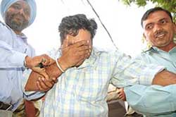 Intelligence Officer of the NCB, Ravikant, being taken into custody by CBI officials in Sector 15, Chandigarh, on Wednesday. 