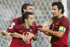 Portuguese forward Simao Sabrosa (centre) is congratulated by Luis Figo (right) after scoring a goal during the Group D match between Portugal and Mexico in Gelsenkirchen on Wednesday. 
