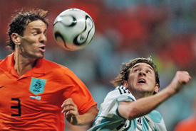 Dutch defender Khalid Boulahrouz and Argentinian defender Fabricio Coloccini battle for the ball during their Group C match in Frankfurt
