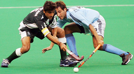Pakistans Muhammad Saqlain and Argentinas Matias Gabriel Cammareri fight for the ball during a pool match of the Sultan Azlan Shah hockey tournament in Kuala Lumpur on Thursday