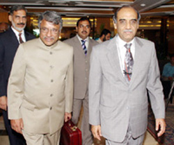 Pakistan's Secretary for Water and Power Ashfaq Mahmood escorts his Indian counterpart J. Harinarayan before a meeting in Islamabad