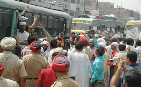 Protesting unemployed teachers board buses after being taken in custody in Ludhiana on Friday