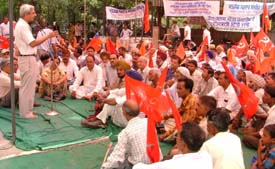 Dr Arun Mitra, assistant secretary, CPI, addresses party workers during a dharna against poor civic amenities in Ludhiana
