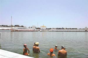 Devotees take a dip in the gurdwara sarovar