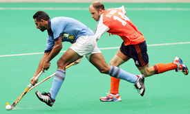 Indias Kanwalpreet Singh is challenged by the Netherlands Teun de Nooijer during the semifinal of the 15th Sultan Azlan Shah Hockey Tournament in Kuala Lumpur on Friday